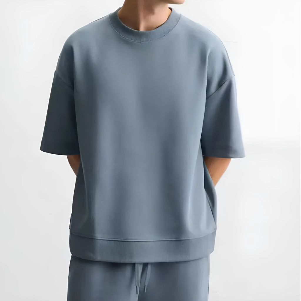 Loose fit short sleeve casual top with double-sided texture in blue, shown with a round collar.
