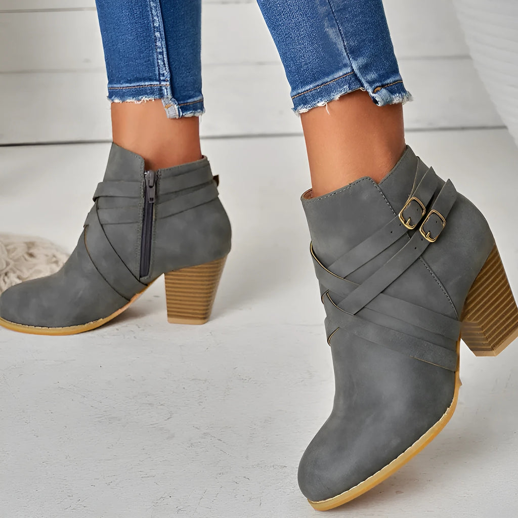 Plus size black short boot with side zipper, buckle, and a 7cm thick rubber heel.