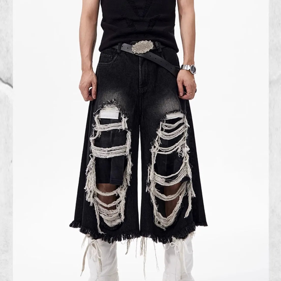 Black cropped wide-leg women's jeans with a ripped patch detail and a mid-high waist.