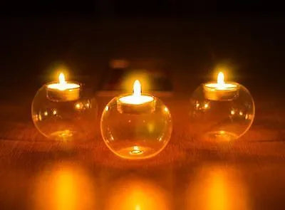Handmade clear round hollow glass candle holder in European style on a table.