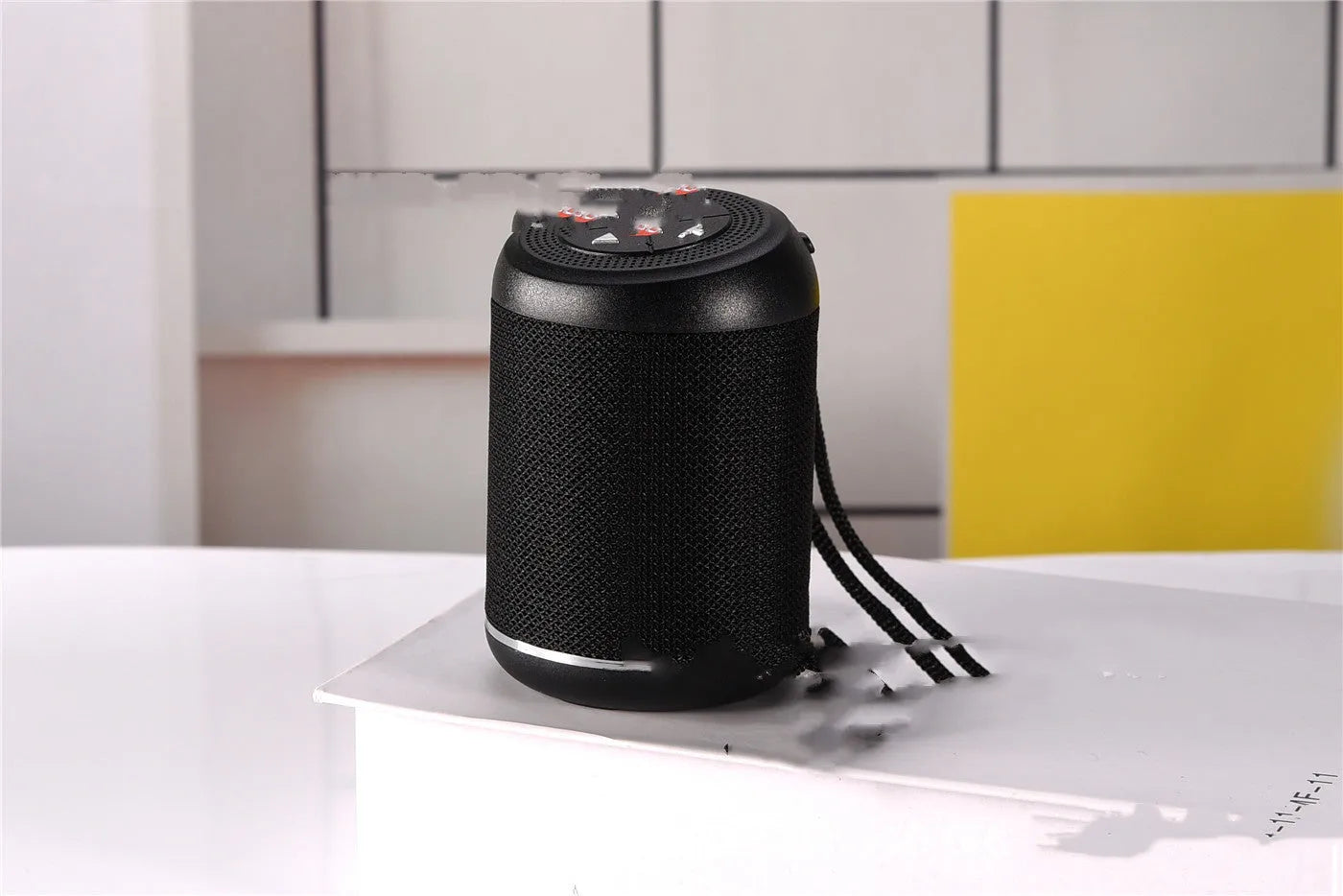 Portable outdoor Bluetooth subwoofer speaker in multiple colour options showing button controls.