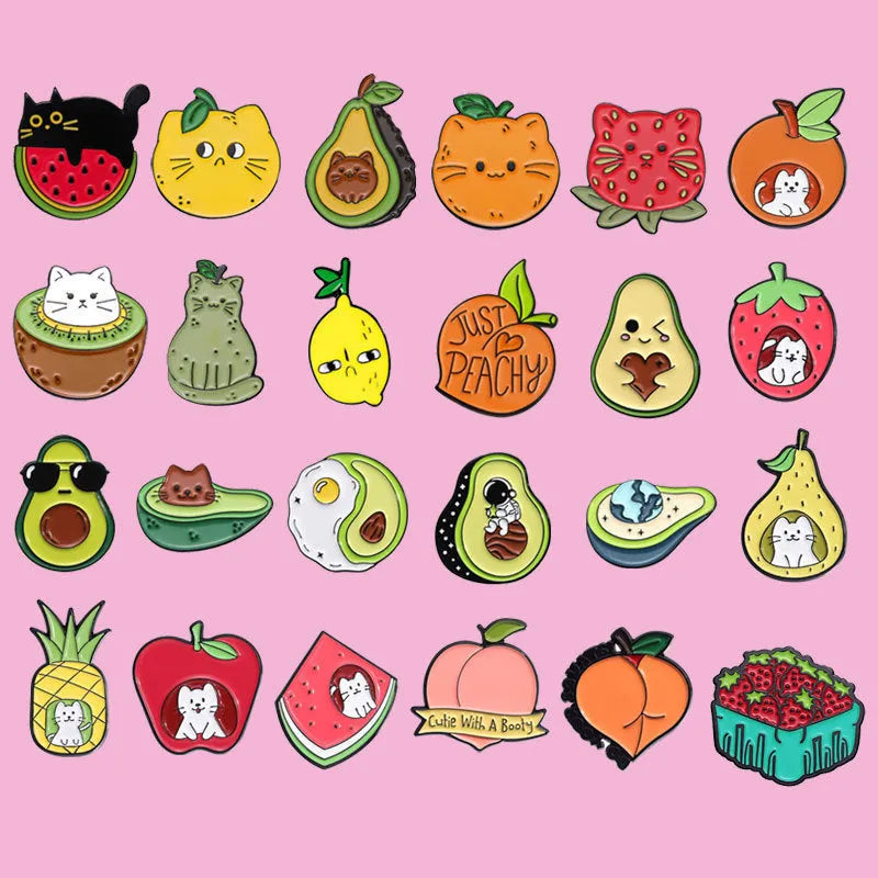 Colourful cartoon-style fruit metal brooch with a pin back on a denim jacket lapel.