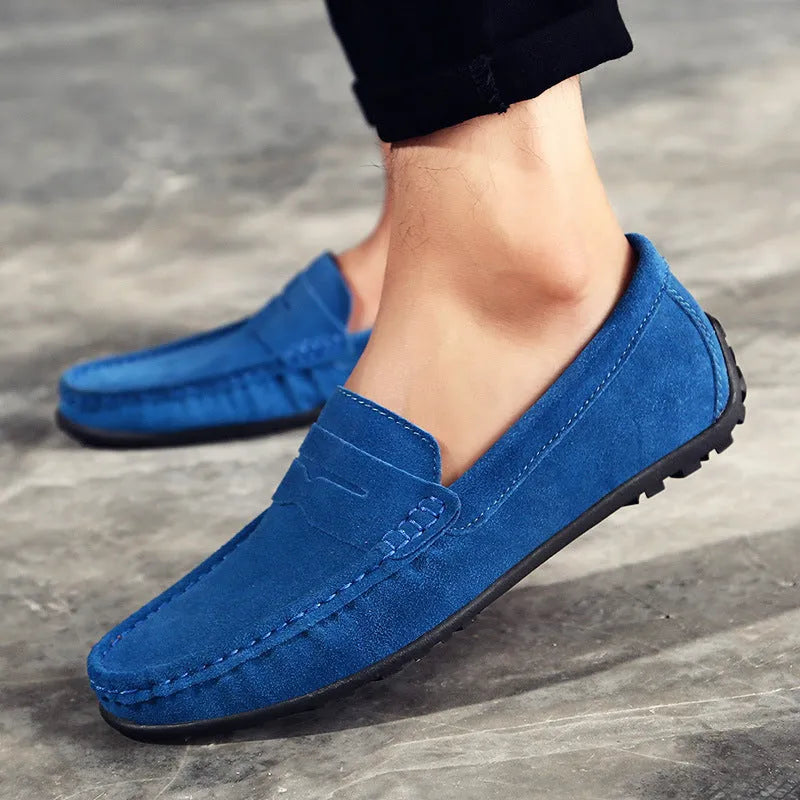 Men's brown suede Gommino casual loafers with a round toe and flat rubber sole.