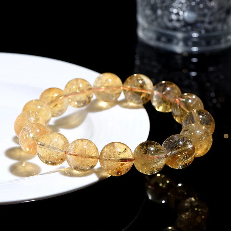 Natural yellow citrine Asestelle bracelet with geometric beads on a wrist.