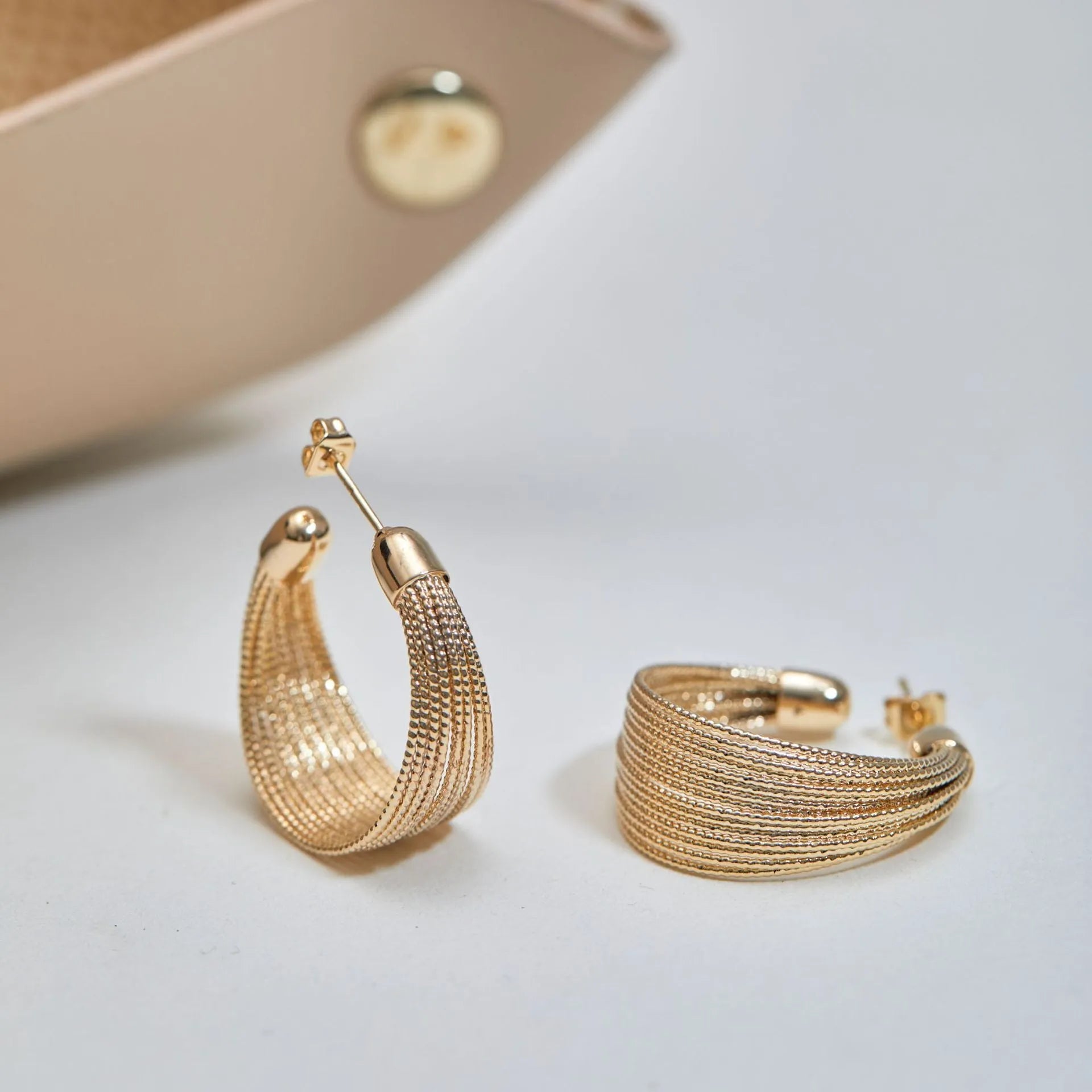 Simple geometric bracelet earrings with clip and stud backs in silver or gold colour.