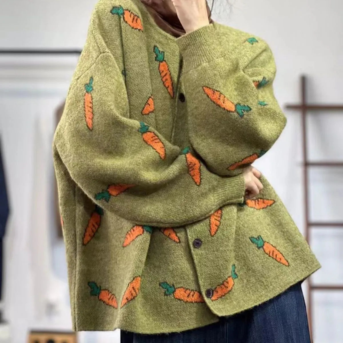 A loose-fitting cardigan with a round neck, artistic printing, and colour contrast details.
