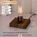 Iron art suspension bulb desktop night lamp on a black square base.