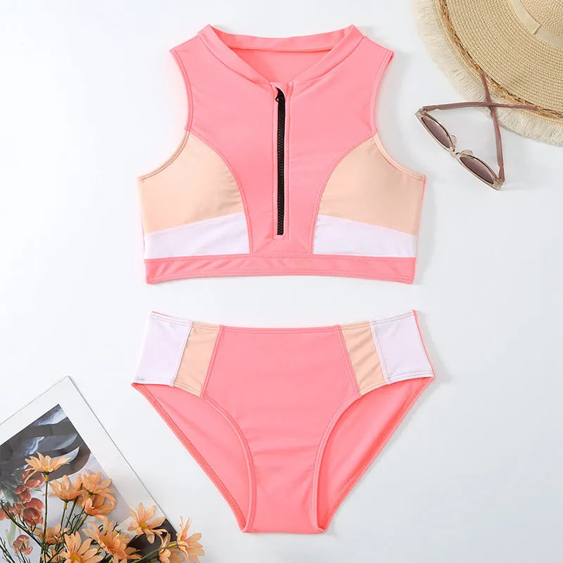Pink high-waist bikini swimsuit with split shorts on a neutral background.