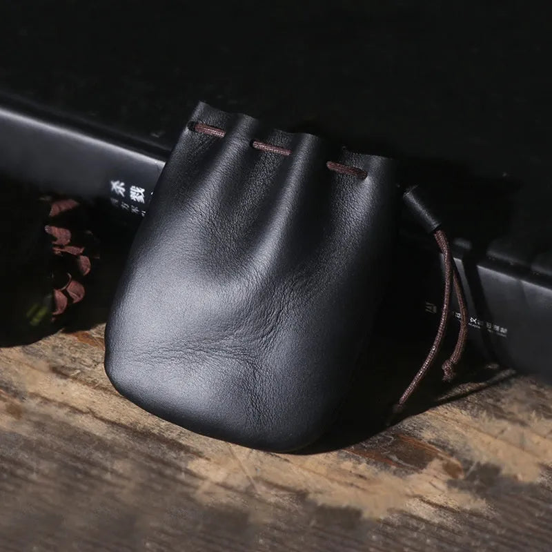 Vintage cowhide leather drawstring pouch wallet in black shown open and closed