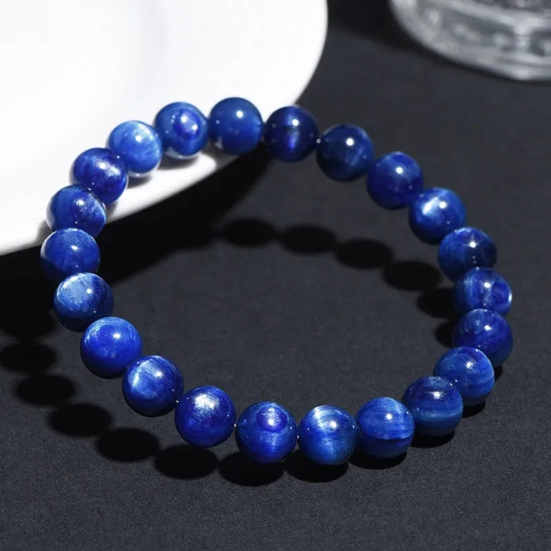 Natural blue grade 7A crystal bracelet with geometric bead and Ruyi charm on wrist.