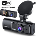 Black dual-lens dashboard camera with 1.5-inch screen mounted on car windscreen suction stand.