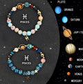 Set of two natural stone beaded bracelets with elastic cords on a wooden surface.