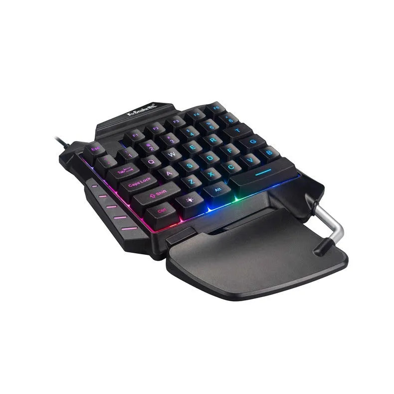Black left-hand throne one-handed gaming keyboard with shortcut keys and wrist rest on a desktop.