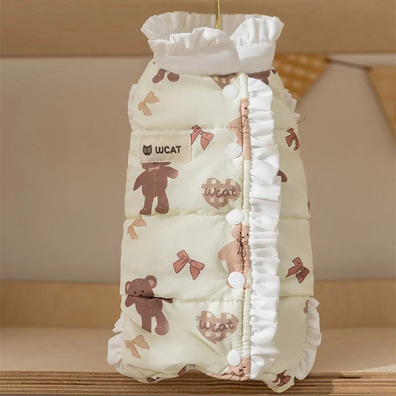 Cream fleece pet jumpsuit with bear print and white ruffles, four-legged design on small dog