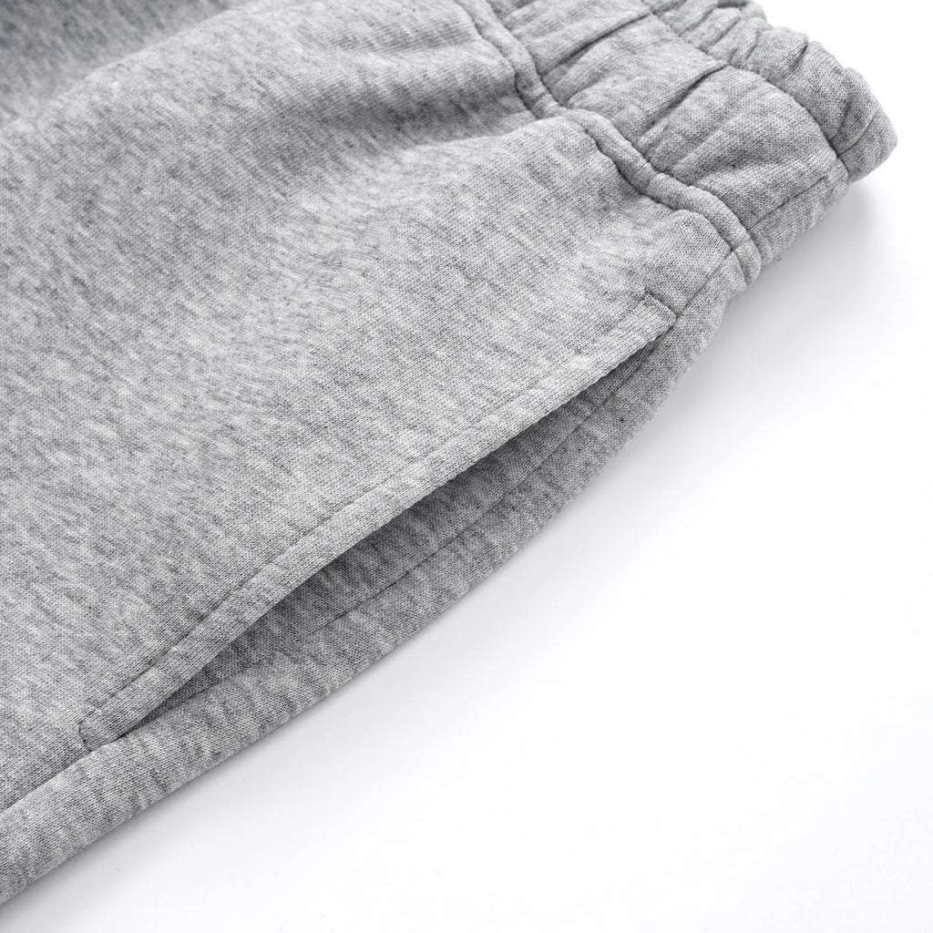 Men's solid colour straight-leg cotton casual trousers shown in black and grey.