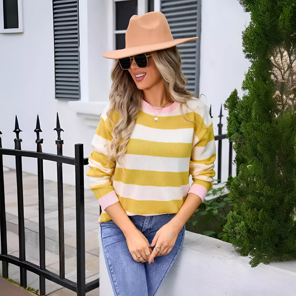 Women's loose fit long sleeve acrylic sweater in blue, showing round neck and regular sleeve.
