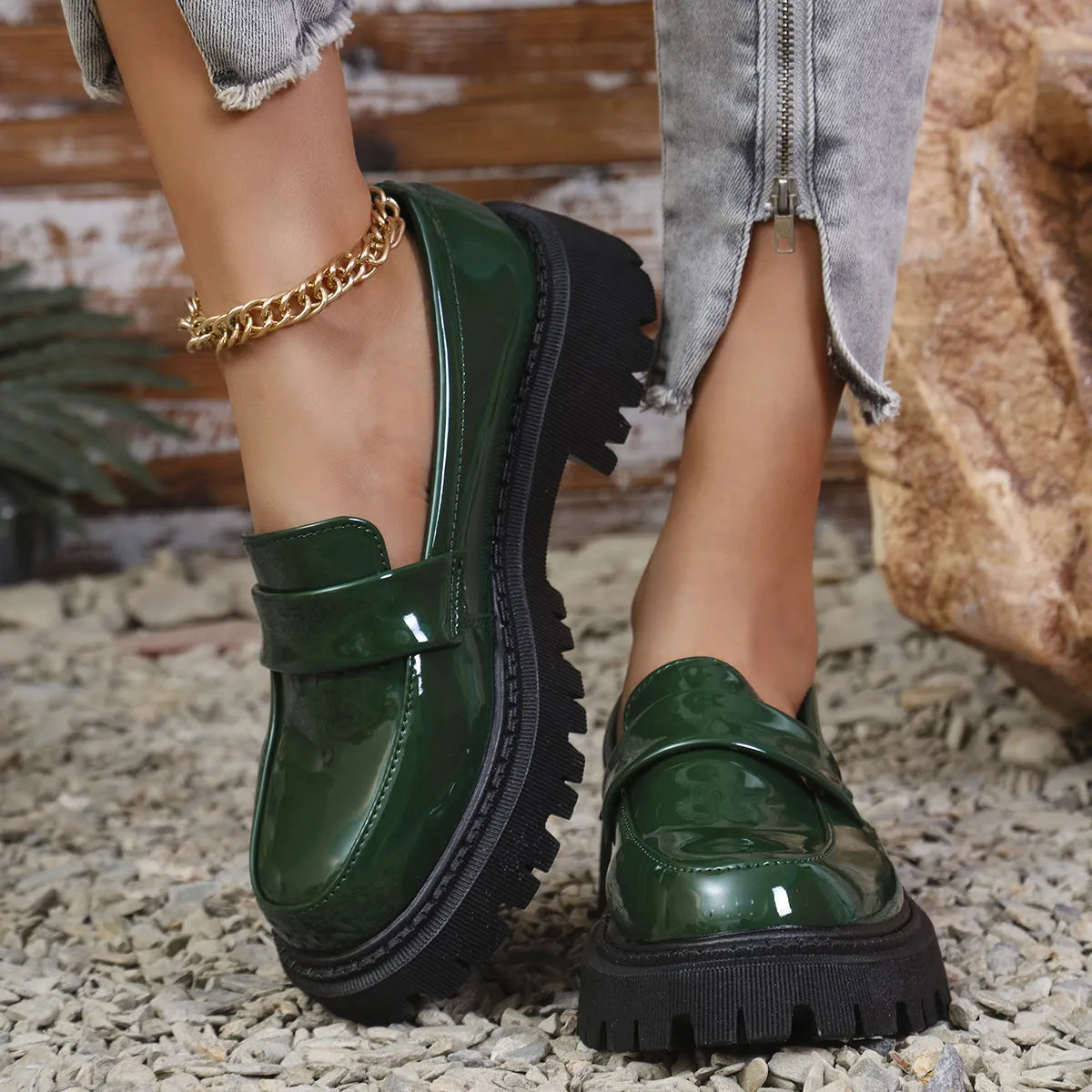 Black slip-on loafers with a chunky platform heel and thick rubber sole.