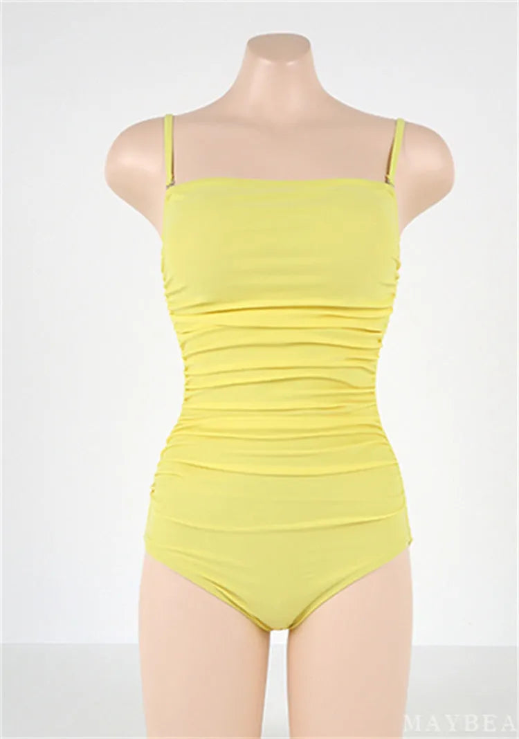 Blue sling style one-piece swimsuit with belly pleating on a mannequin.