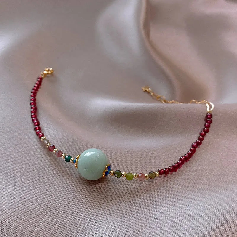 Aquamarine garnet bracelet with drop-shaped tourmaline centrepiece on wrist