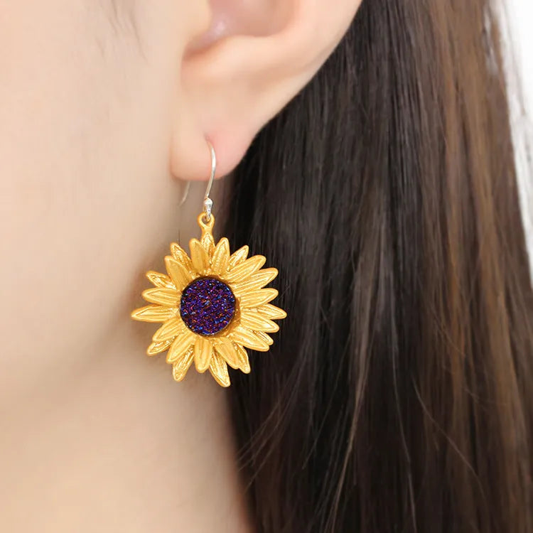 Gold-plated copper sunflower ear hook earrings with 4cm dangle length on a white background