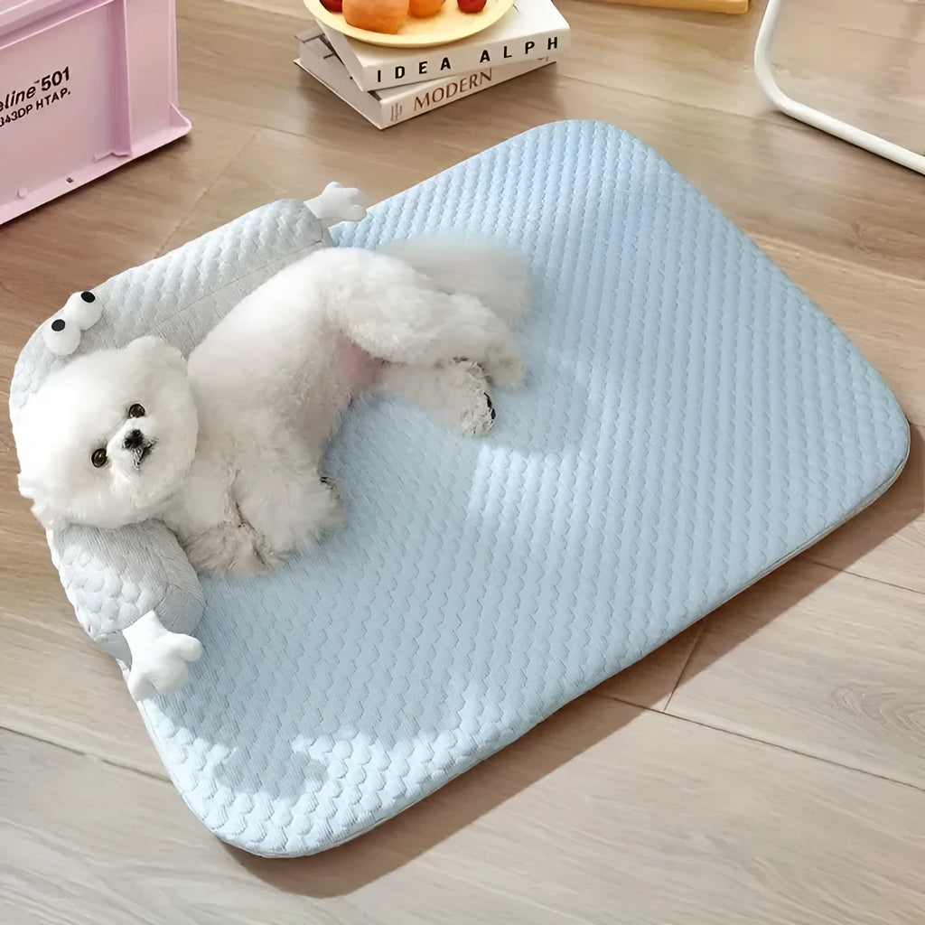 Blue monster design non-slip pet cooling bed for a dog on a hardwood floor.
