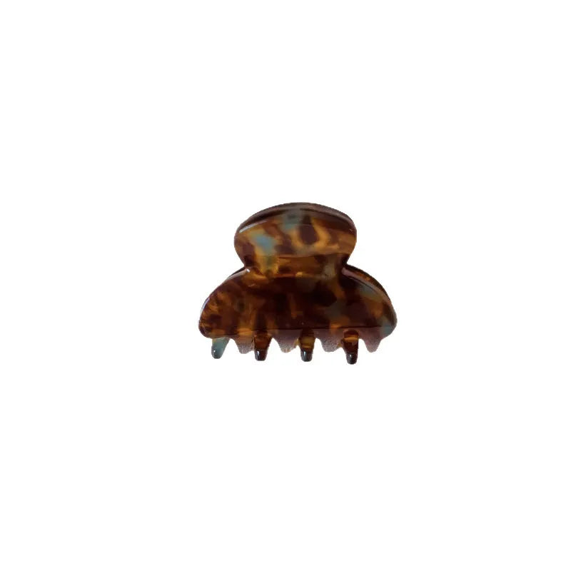 Mini jaw clip back head hairpin for women in acetic acid, shown in six colour options including coffee hawksbill and bright black.