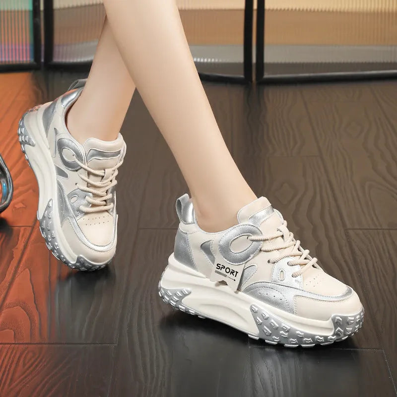 A pair of thick-soled leather casual sports shoes in a black and white colourway with a lace-up front.