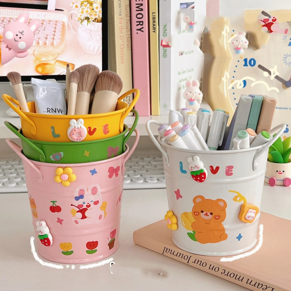 Round metal creative iron art pen holder in various colours on a desk.