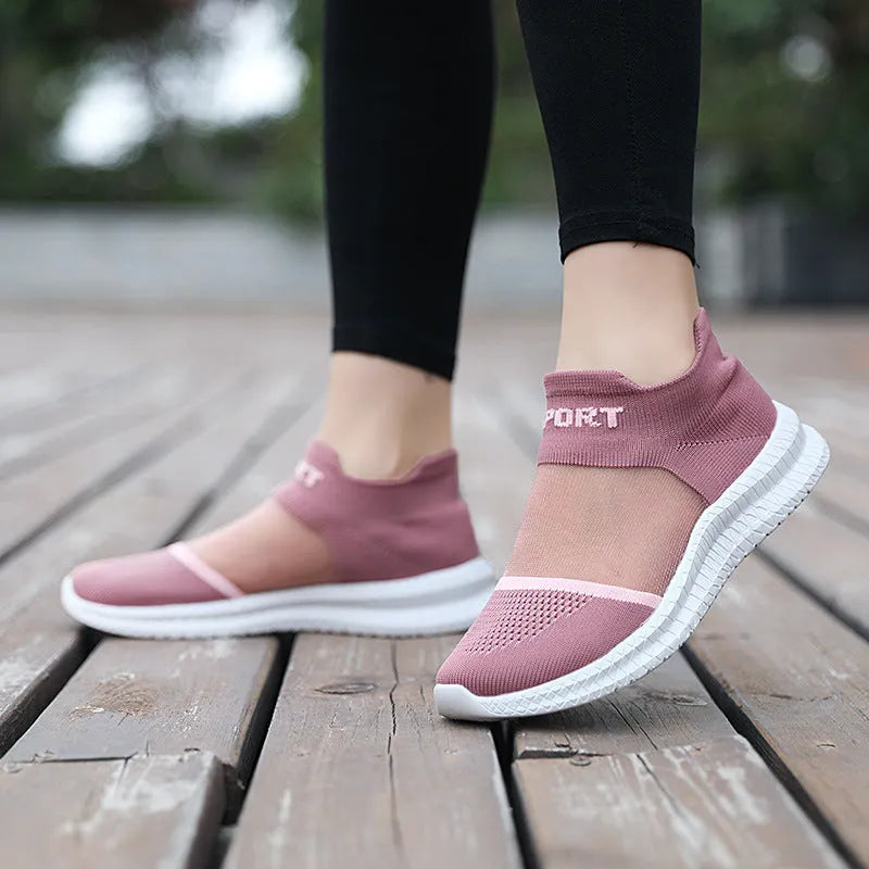 A pair of khaki Flyknit sock shoes with lace closure and a low-top design on an MD sole.
