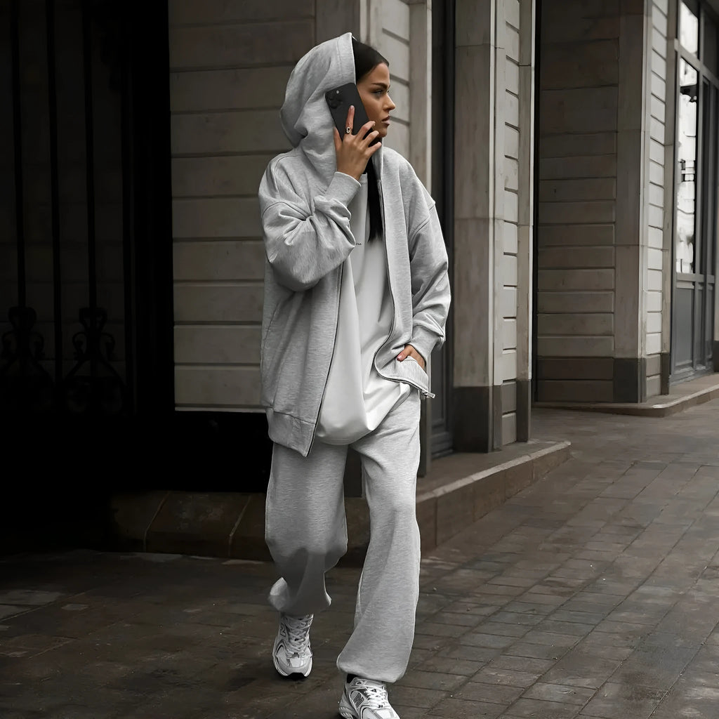 Red loose-fit street style two-piece set with long-sleeved coat and trousers on a model.
