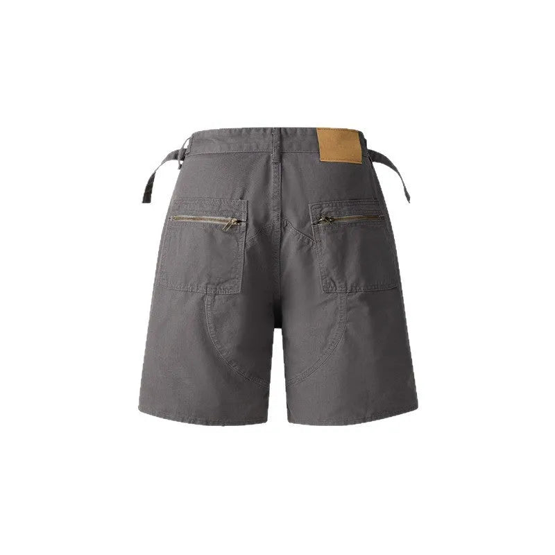 Retro loose-fit workwear shorts for men and women in washed cotton fabric with a zipper closure.