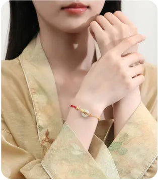Gold koi peace buckle bracelet made from 925 silver with red rope closure