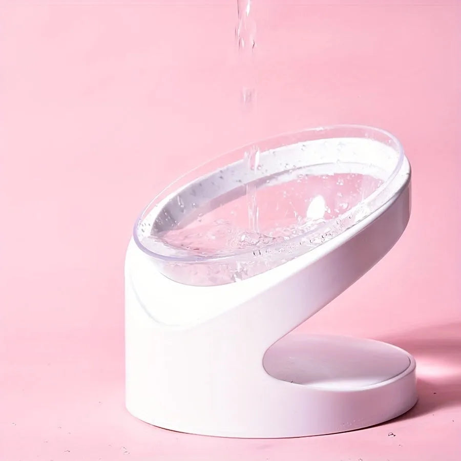 White clear plastic elevated cat food bowl with tilted ergonomic design for neck protection.