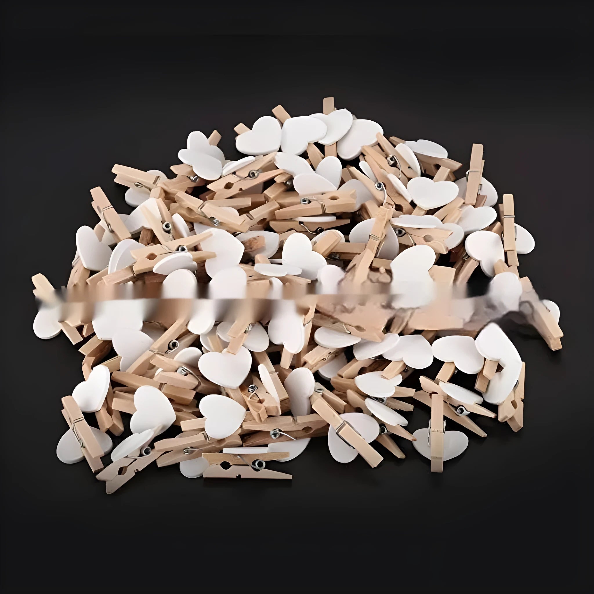 Set of five handmade solid wood heart-shaped clips in assorted colours on a wooden surface.