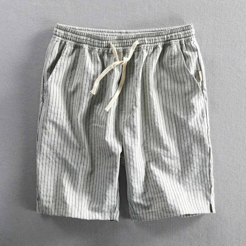Men's striped casual shorts with elastic waistband in turmeric colour showing loose straight cut