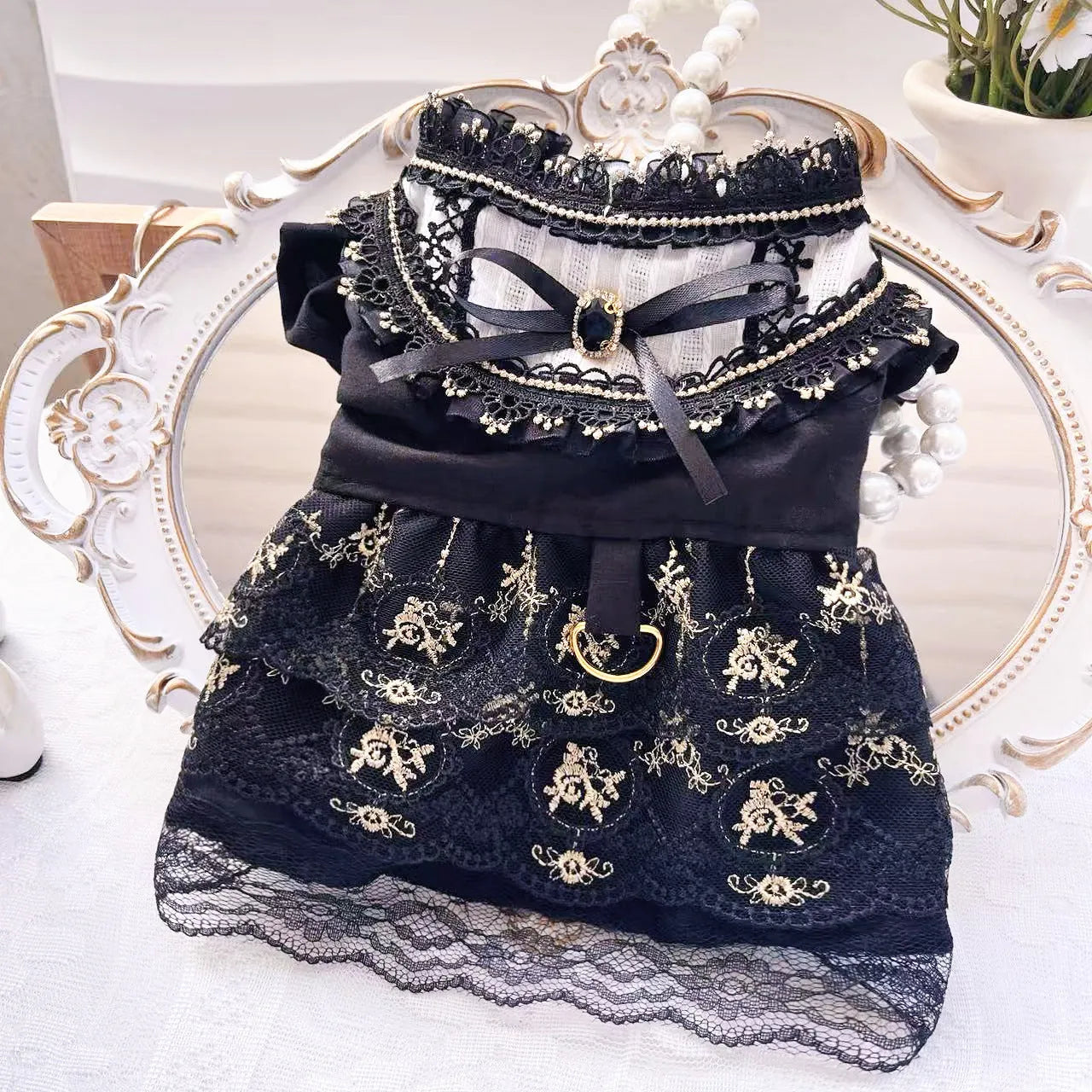 Golden tiered gothic-style skirt for a small dog on a mannequin, showing princess design.