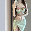 Green women's triangle bikini three-piece set with skirt on Asian size mannequin