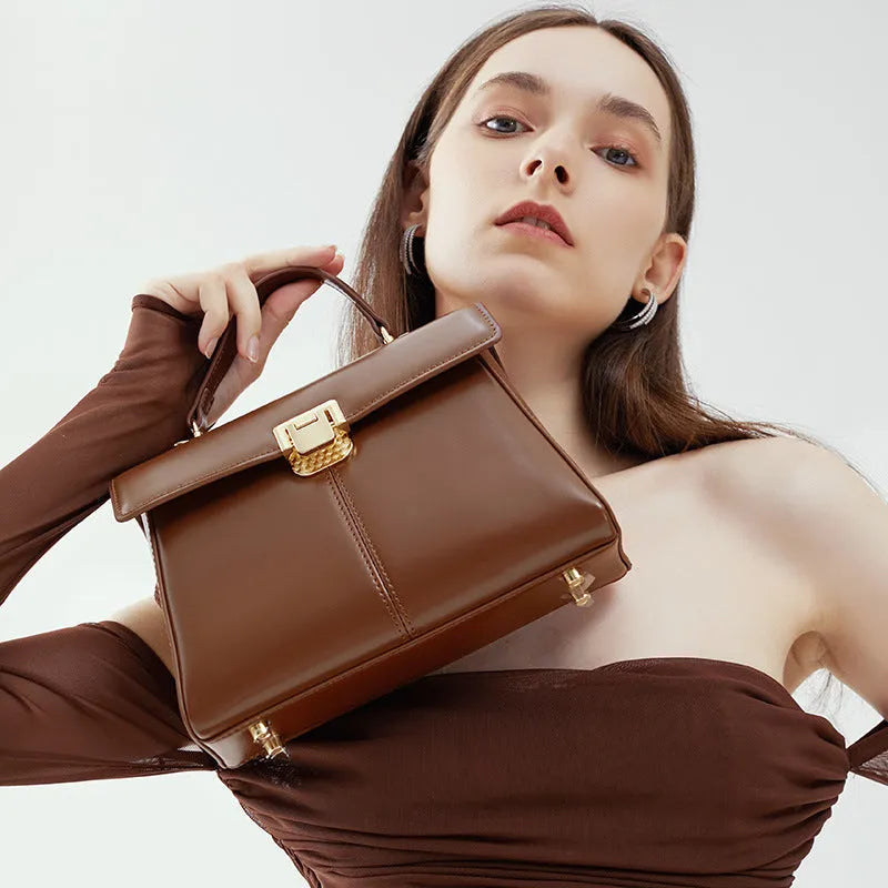 Dark brown women's genuine leather shoulder bag with a metal Vachette clasp, shown open to reveal an interior zippered pocket.