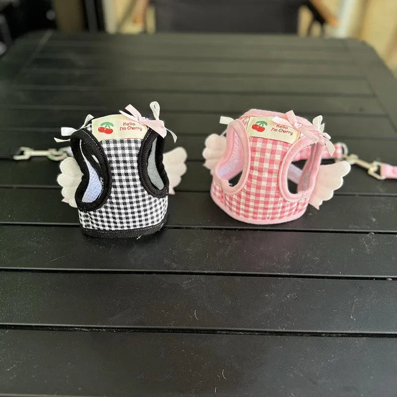 Pink cotton harness and lead set for a small dog with chest and back attachment points.