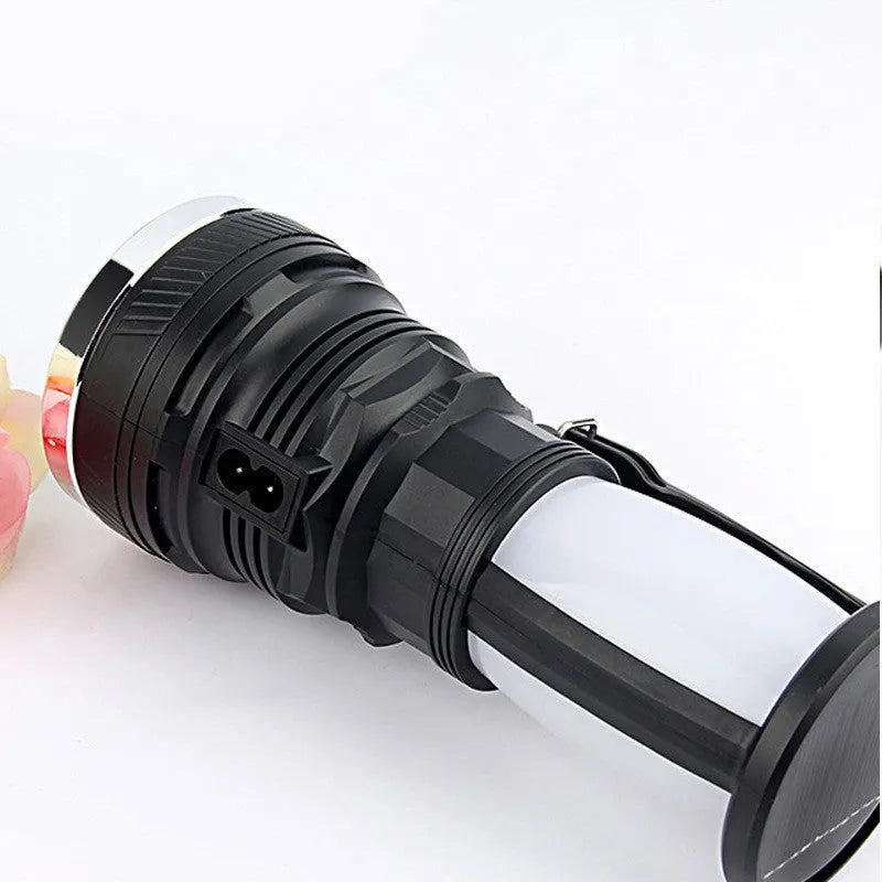 Black solar and USB rechargeable LED flashlight with a press switch.