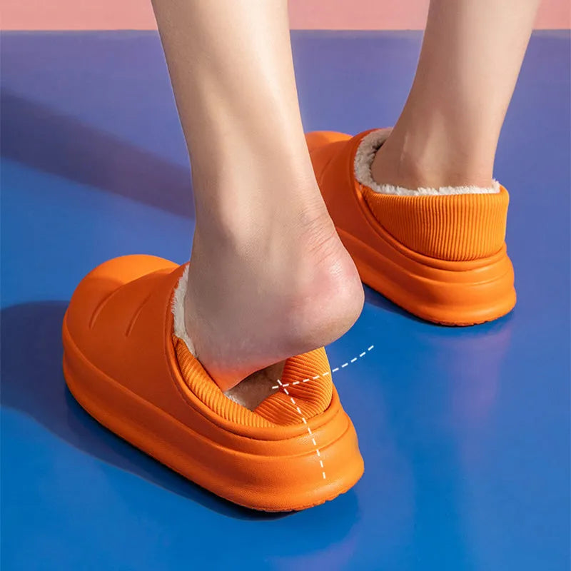 Women's winter slippers in green with plush lining and textured EVA sole, shown as sleeve-style overshoes.