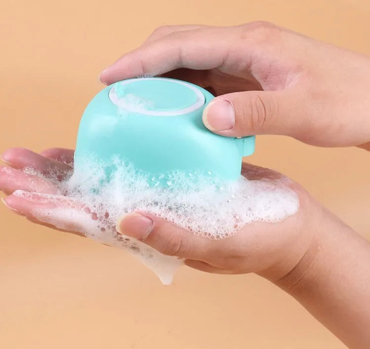 Blue silicone dog bath brush with flexible fingers for grooming and massage during pet baths.