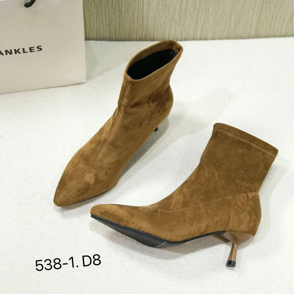 Black pointed toe women's ankle boots with a stiletto heel on a mid-calf shaft.