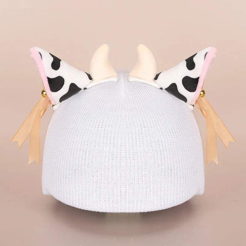 Colourful plush cartoon hat decoration sitting on top of a ski helmet