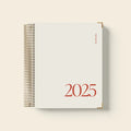 Cherry red coil-bound notebook open on desk showing flat-lying pages for comfortable writing