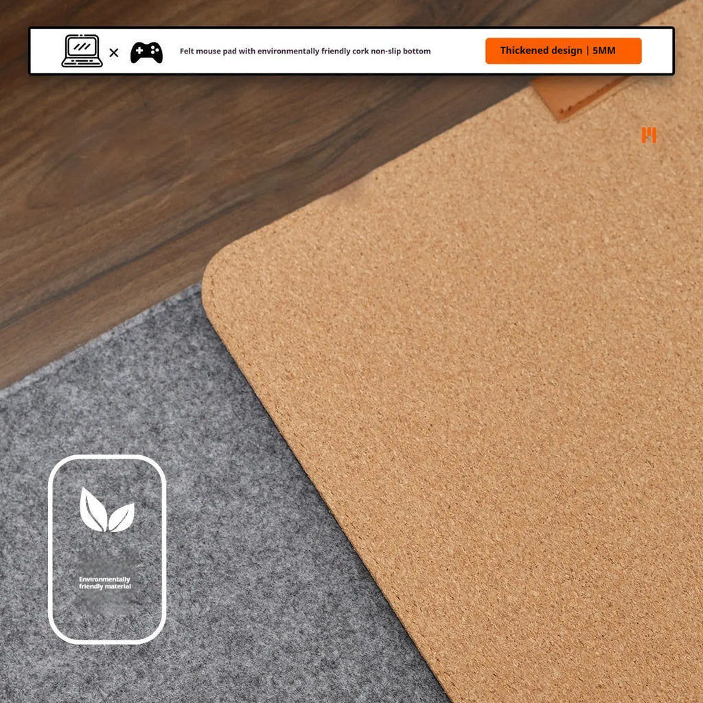 Oversized felt cork desk mat in black and grey pattern on a wooden desk