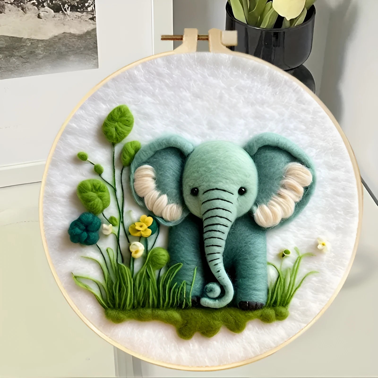 Round fabric embroidery kit with linen square, wool felt, and embroidery frame for handmade decorations.