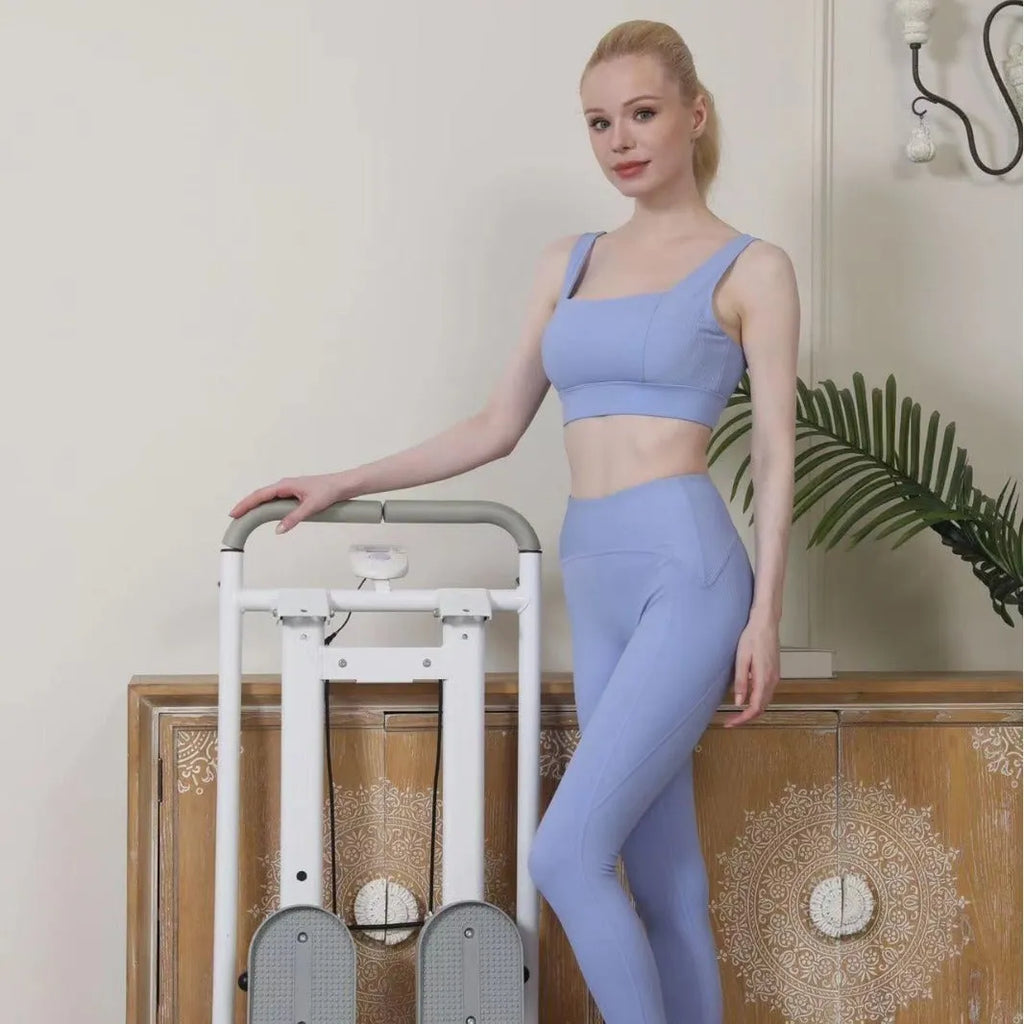 White foldable treadmill with attached indoor climbing frame for home gym use