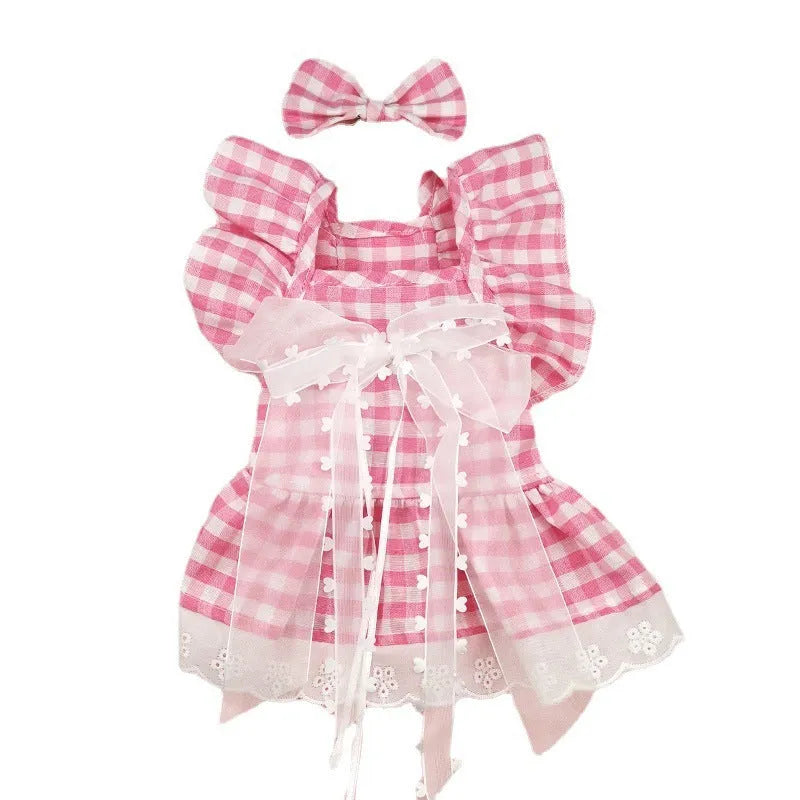 Breathable lace and plaid gauze dog skirt in Pink Daisy with matching bow necklace on a small dog