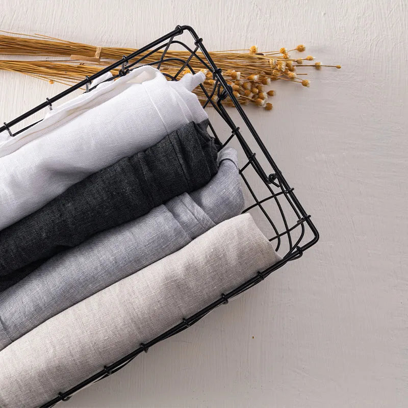 Men's straight-leg linen trousers in a mid waist cut, shown in a neutral colour.